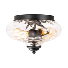 a light that is on top of a glass bowl ceiling fixture in an old - fashioned style