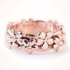 a close up of a ring with flowers on it