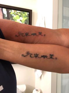 two people with tattoos on their legs and one has the word love written in cursive writing