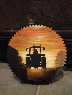 a painting of a tractor in front of a fire place with the setting sun behind it