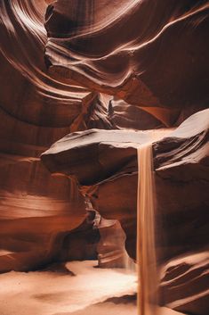 a small waterfall in the middle of a canyon