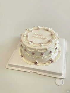 a large white cake sitting on top of a table