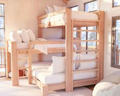 a room with bunk beds and white pillows