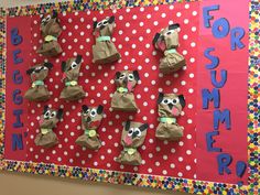 a bulletin board decorated with paper bags and dog puppets on it's sides, reading for summer