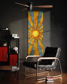 a living room with a black chair and a yellow sun art piece on the wall