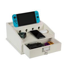 a nintendo wii game console sitting on top of a white desk with drawers underneath it