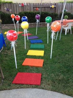 an outdoor play area with colored stepping stones and candy canes