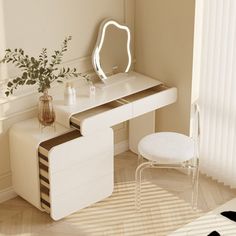 a white vanity table with a mirror and stool in front of a window next to a plant