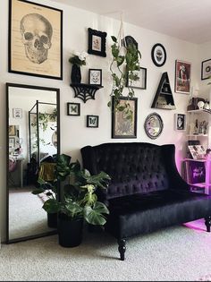 a living room filled with furniture and pictures on the wall