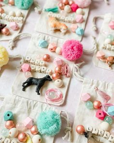 several small bags filled with different types of bead and charms on top of a table