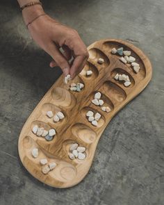 Mancala games are a family of turn-based strategy board games for two players played with small stones, beans or seeds and a series of holes or openings in the ground, board or other playing surface. The goal is usually to capture all or some set of the opponent's pieces. Each game is unique, so we give you the opportunity to see all the options available. You can choose the exact commission before or after your purchase. HOW TO PLAY https://www.youtube.com/watch?v=OX7rj93m6o8 We use FedEx for delivery. So you can receive your game in 3-7 business days. Mancala Board, Pottery Games, Mancala Game, Board Games For Two, Strategy Board Games, Wood Games, How To Make Clay, Ceramics Projects, Wood Creations