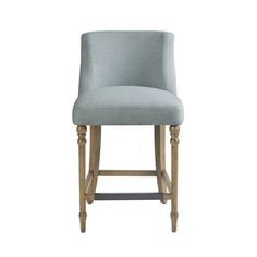 an upholstered bar stool with wooden legs and a light blue fabric seat cover