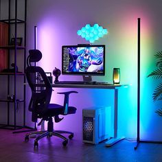 a desk with a computer monitor, keyboard and mouse on it in front of a neon colored wall