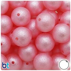 some pink balls with white dots on them are in the middle of a photo and there is