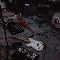 guitars and amps are sitting on the floor