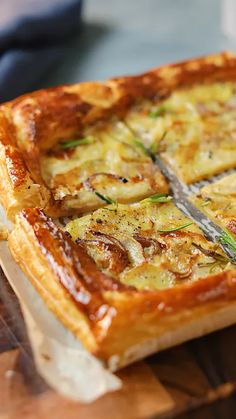 a square casserole on a cutting board with a knife stuck in the crust