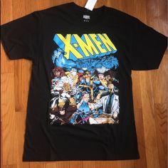 a t - shirt with an image of the x - men on it sitting on a wooden floor