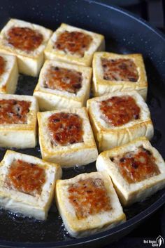 square pieces of food cooking in a frying pan