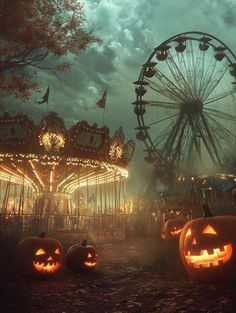 two pumpkins in front of an amusement park with ferris wheel and lights on at night