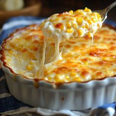 a spoonful of macaroni and cheese being lifted from a casserole dish