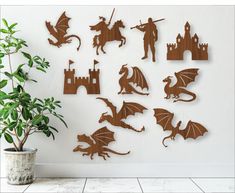 a white wall with wooden cutouts of dragon, knight and castle