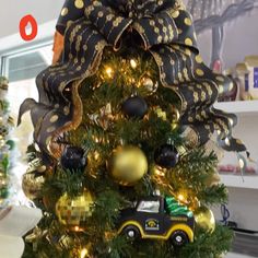 a christmas tree decorated with black and gold ornaments