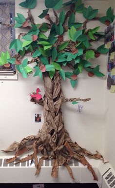 a tree made out of paper sitting on top of a shelf