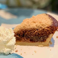 a piece of cake and whipped cream on a plate