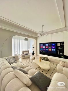 a living room filled with lots of furniture and a flat screen tv mounted on the wall