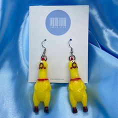 We have the most iconic earrings of all time - mini rubber chicken earrings! Our unique rubber chicken earrings are a fun way to make your outfits more interesting and everyone will be 'chicken' you out! Please note: these earrings do not make a sound when squeaked. Approximate Dimensions (Excluding Hooks): Height: 6.2cm Width: 2.2cm Material: Rubber Care instructions: For best results, please keep these away from water, perfume and other chemicals. Store in a cool, dry place. Disclaimer: Our earring hooks are typically friendly on the skin, however they may not be suitable for hyper-sensitive and hyper-allergic skin. This includes our stainless steel and sterling silver earrings. Strange Earrings, Weird Earrings Aesthetic, Chicken Earrings, Weird Earrings, Crazy Earrings, Rubber Chicken, Funny Earrings, Water Perfume, Quirky Earrings