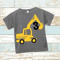 a toddler's construction truck birthday shirt with the number three on it