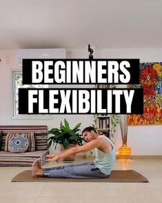 a man sitting on top of a yoga mat in the middle of a living room