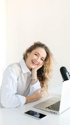 a woman sitting in front of a laptop computer