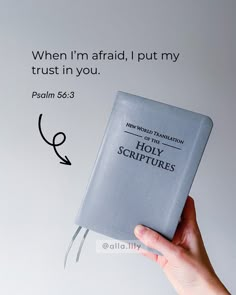 a hand holding a bible with the words, when i'm afraid, i put my trust in you