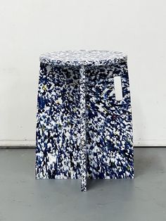 a blue and white table sitting on top of a floor