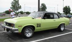 a green car parked in a parking lot