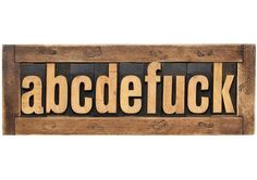 the word abcdefuck written in wooden type