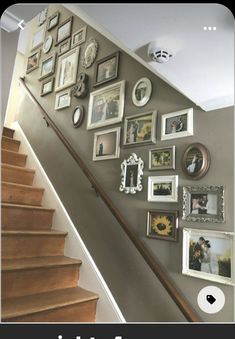 a staircase with many pictures on the wall