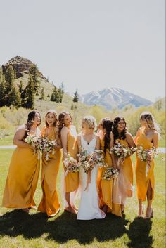 a group of women standing next to each other on top of a lush green field