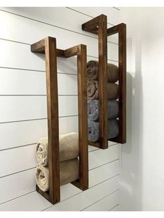 two wooden shelves holding towels and folded towels