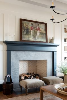 a living room filled with furniture and a fire place in front of a painting on the wall