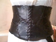 the back of a woman's corset made out of leather