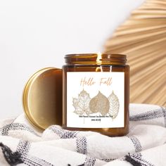 a jar of honey sitting on top of a blanket