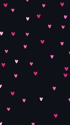 pink and black hearts are arranged in the shape of heart shapes on a black background