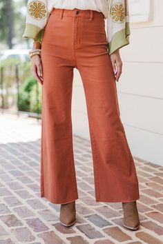 These wide leg, crop jeans are so cute! We love that bold rust coloring and no distressing other than those raw hems. These jeans are going to be a great addition to your wardrobe! Button/zip front closure High waist Pockets Wide legs Cropped... Black Tie Dress, Long Sleeve Outerwear, Cute Spring Outfits, Cute Rompers, Sweater Tank Top, Rust Orange, Casual Work Outfits, Crop Jeans, Shoes With Jeans