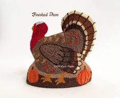 a stuffed turkey sitting on top of a white surface with the words finished item written below it