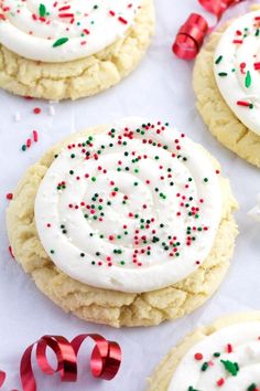 cookies with white frosting and sprinkles on top