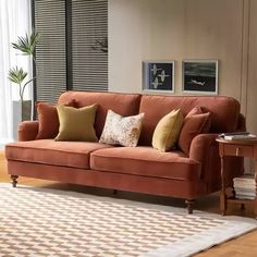 a living room scene with focus on the couch and rug in front of the window