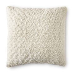 a white pillow that is made out of sheep fur and has a square pattern on the front