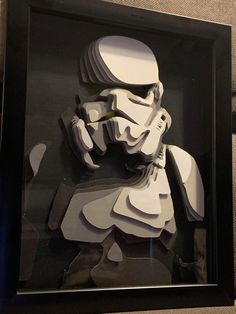 a star wars paper cutout is displayed in a black frame